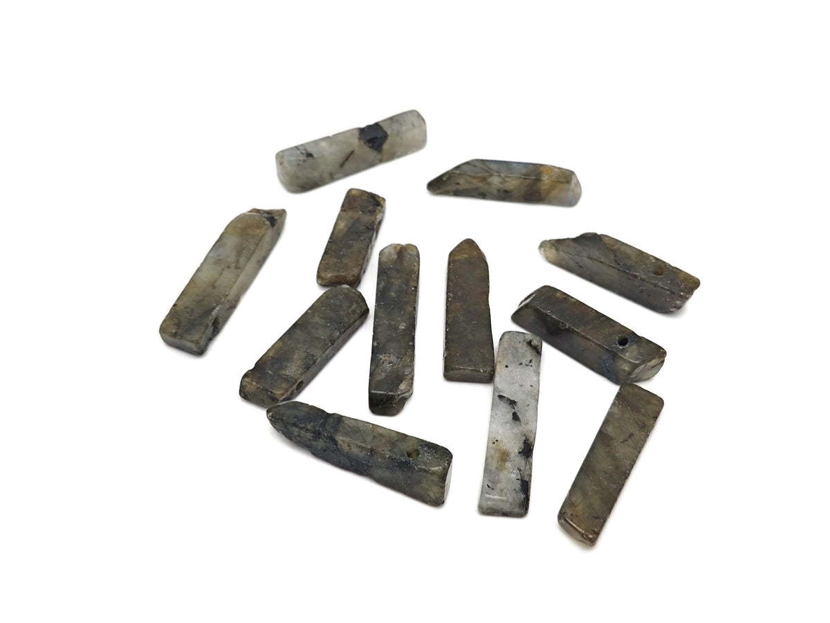 Labradorite drilled tumbled gemstone pendant from GemstoneGO showing iridescent gray-blue labradorite stone with drilled hole for jewelry.