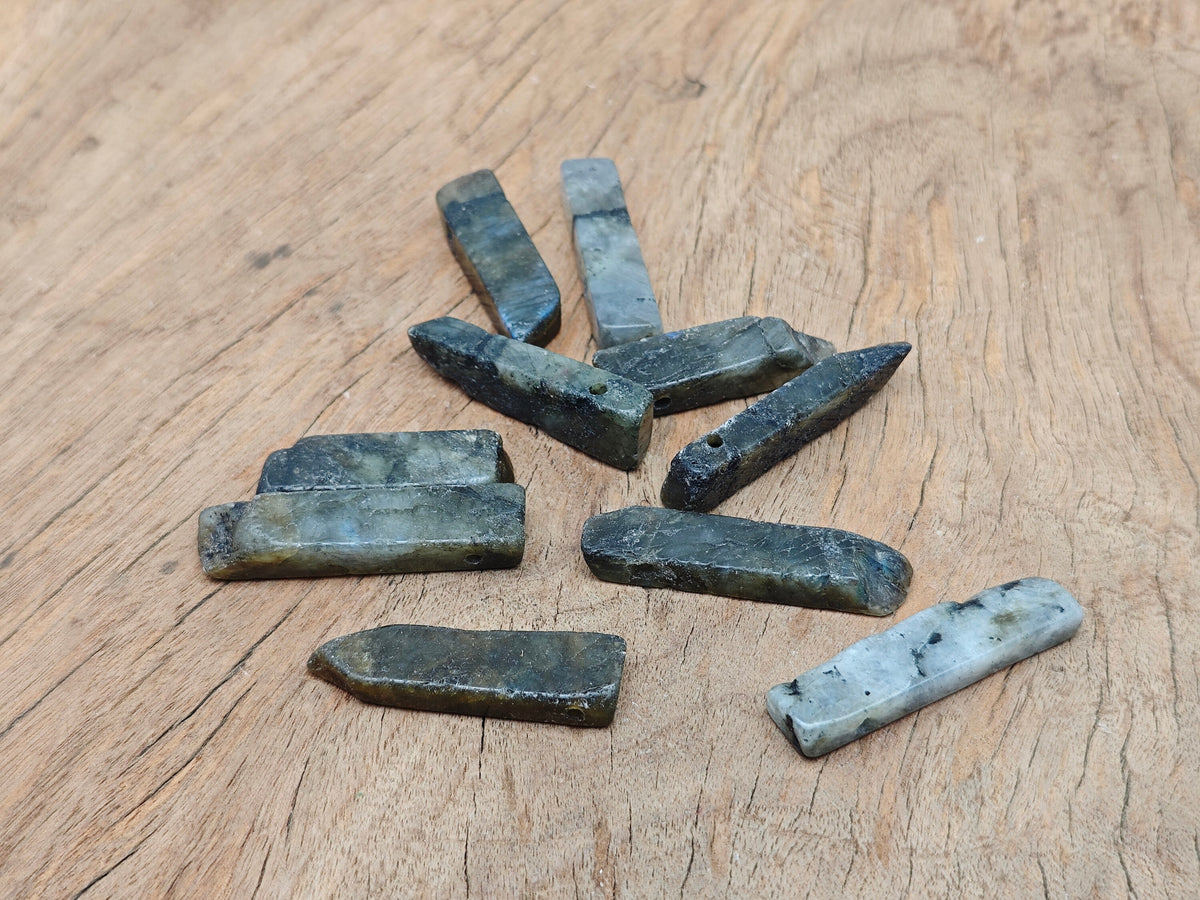 Labradorite drilled tumbled gemstone pendant from GemstoneGO showcasing iridescent flash and smooth polished surface.