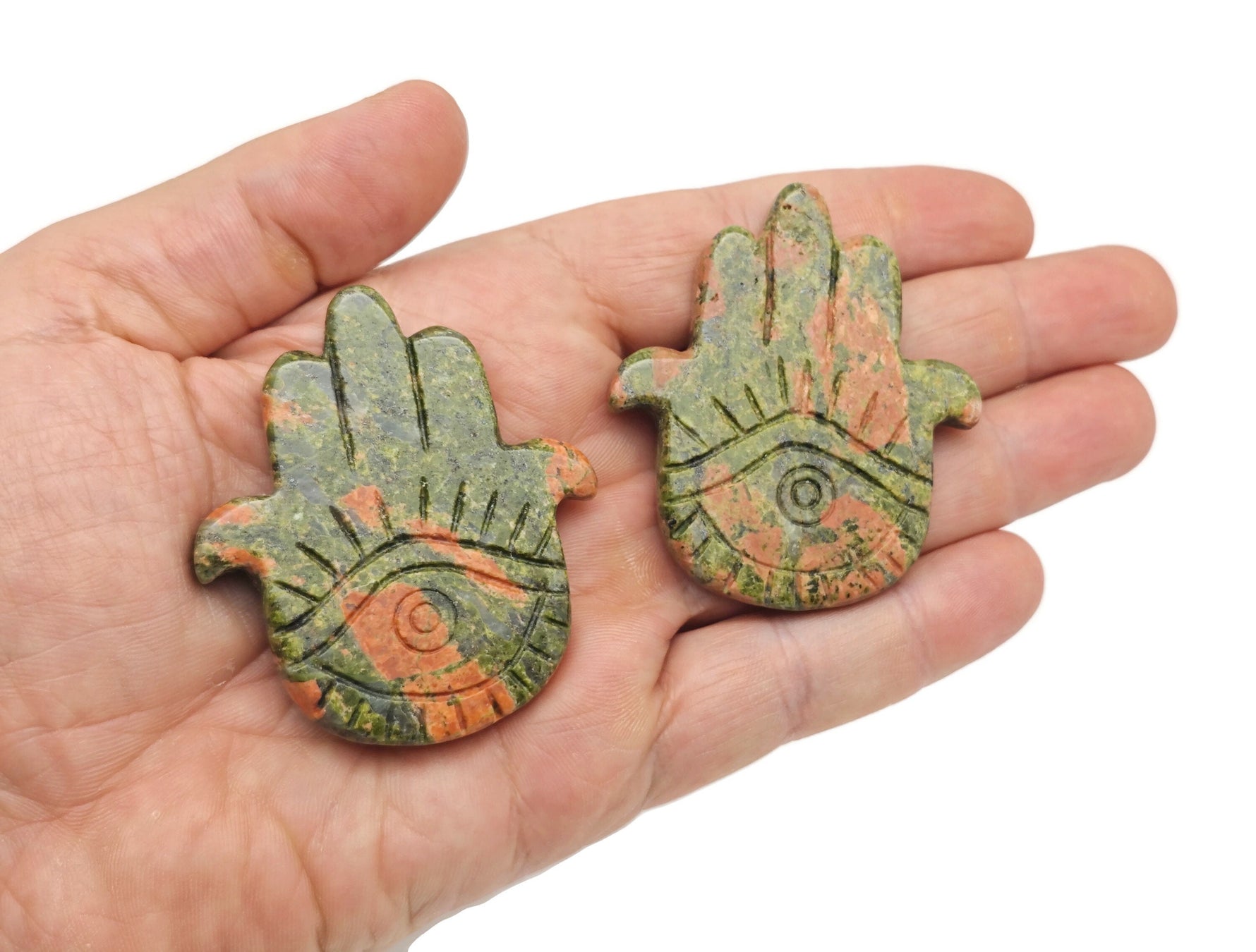 Evil Eye hand gemstone carving pocket crystal with chakra and meditation stones, featuring vibrant gemstone colors and intricate detailing.