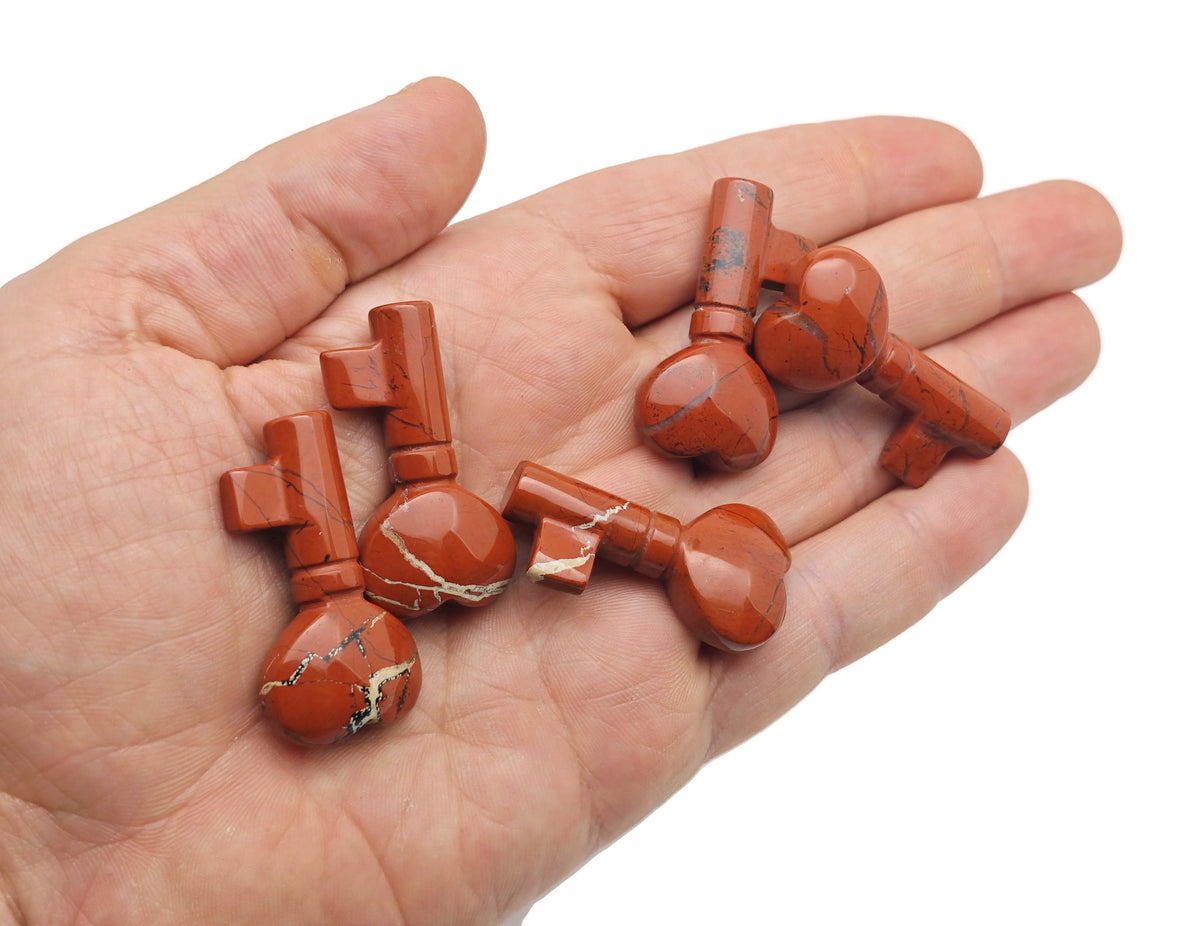 Red Jasper gemstone key carving, 40mm, from GemstoneGO, showing a polished red jasper key-shaped carving with intricate details.
