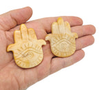 Yellow jade evil eye hand gemstone carving with intricate details, showcasing a vibrant yellow color and craftsmanship by GemstoneGO.
