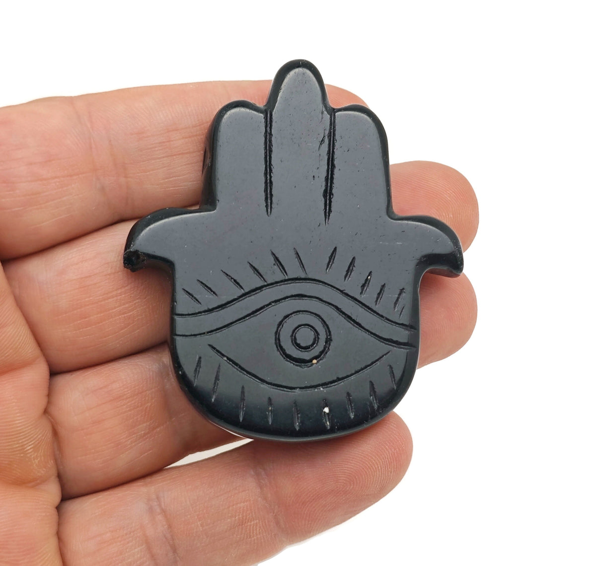 Obsidian Evil Eye hand-carved gemstone pendant from GemstoneGO, featuring intricate evil eye design on smooth black stone.