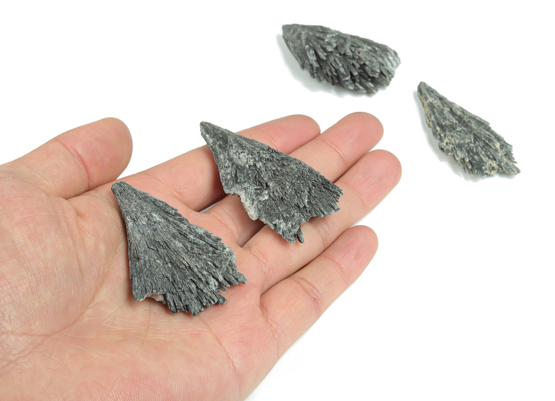 Aura Kyanite fan gemstone in various colors, raw crystal form, showcasing vibrant, natural mineral textures and fan-shaped structure.
