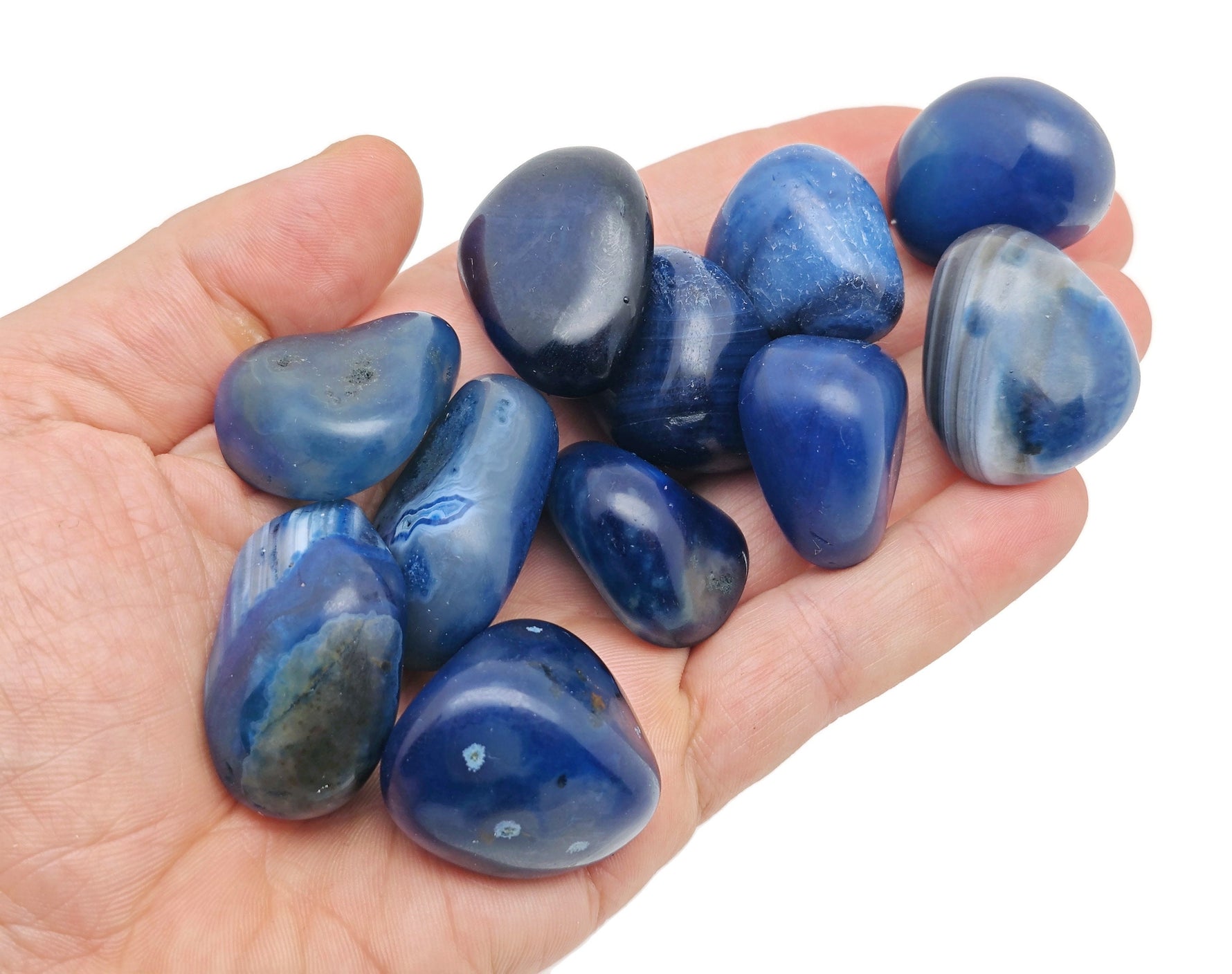 Blue Agate tumbled stone from GemstoneGO, smooth polished gemstone with vibrant blue and white banding, ideal for healing and decoration.