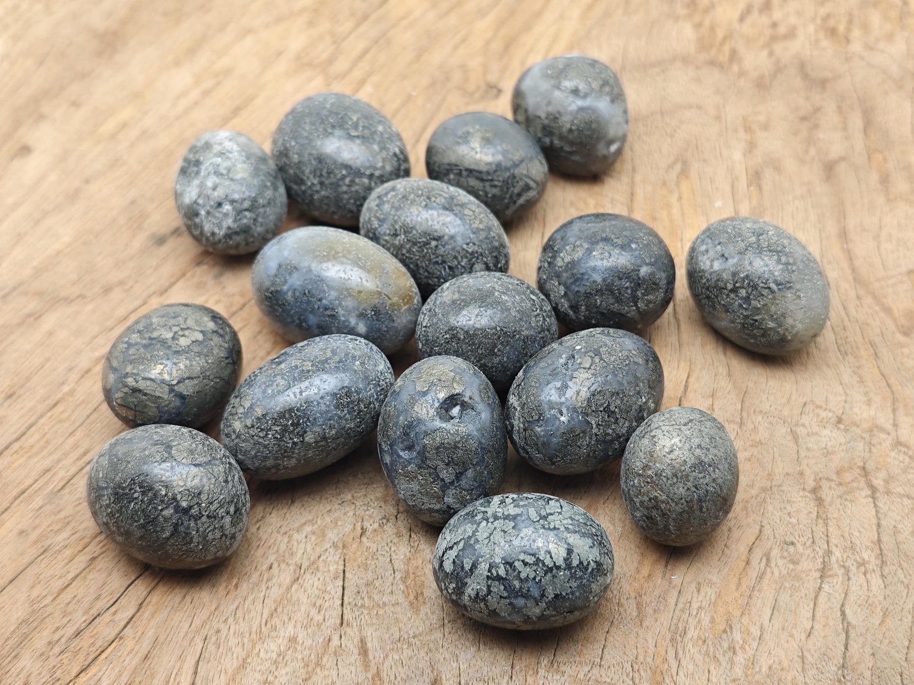 Cooper Agate tumbled stone from GemstoneGO, showing smooth, polished brown and beige banded gemstone with natural patterns.
