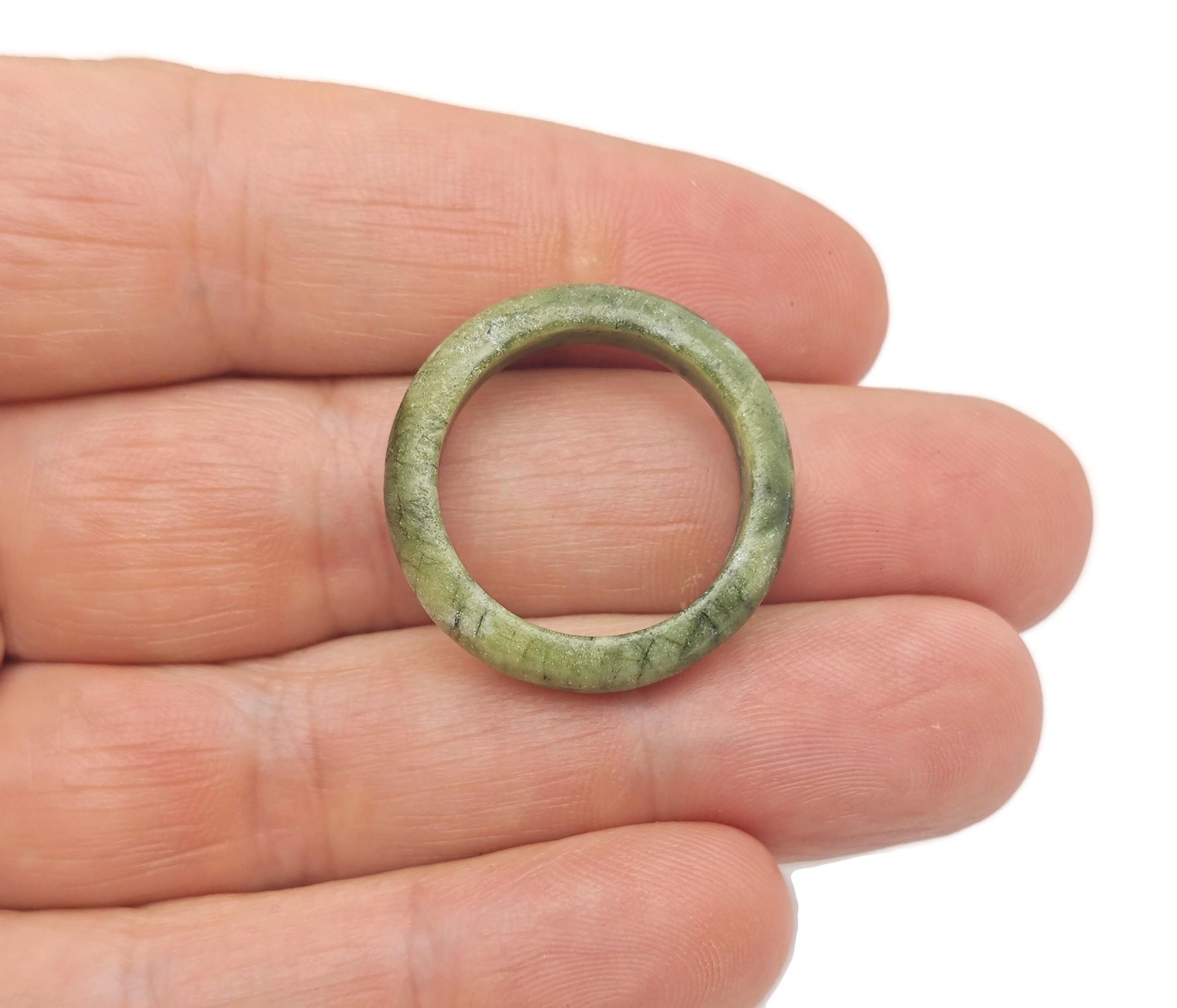 Nephrite jade crystal ring with a polished band, featuring a smooth green gemstone, from GemstoneGO's jewelry collection.