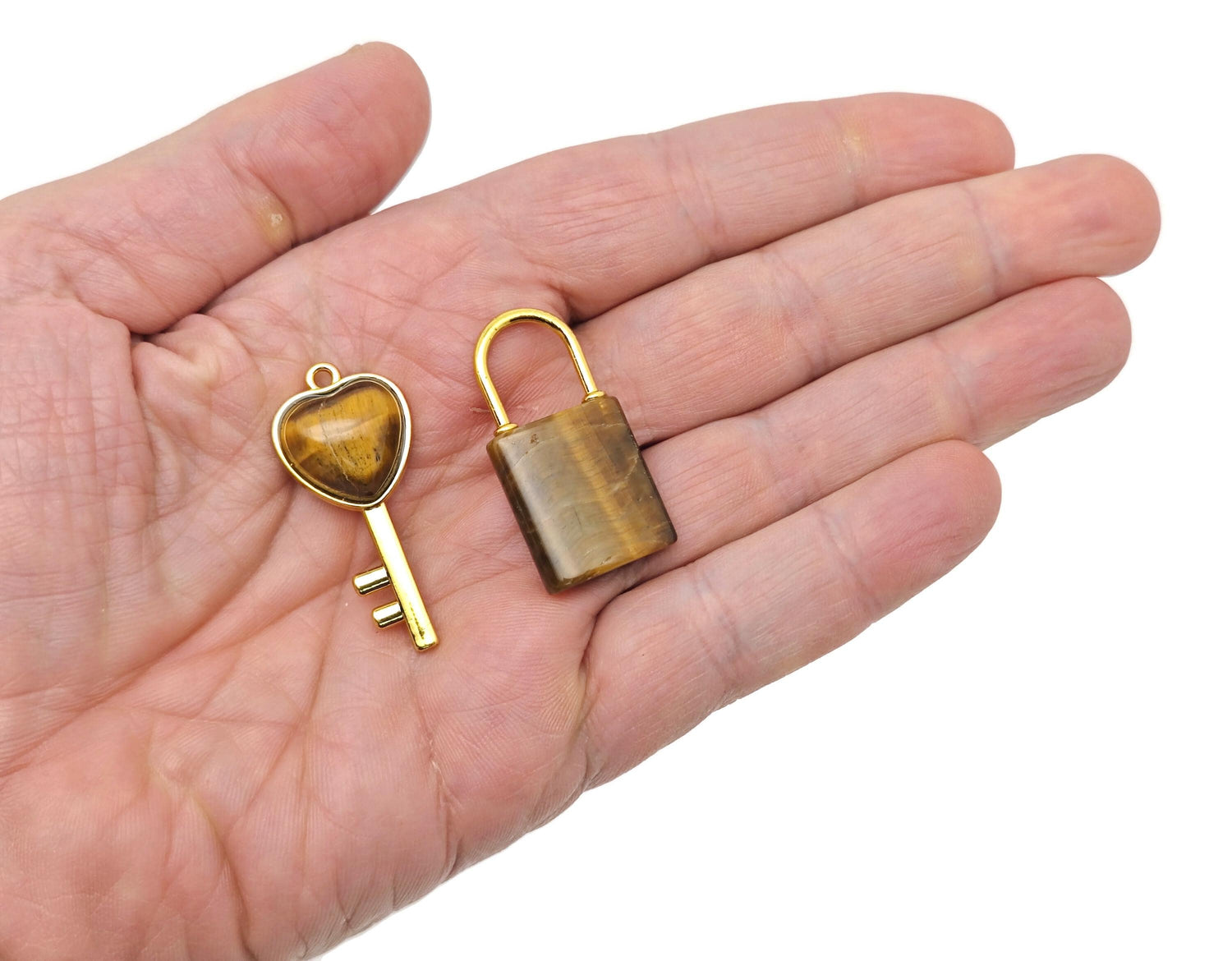 Tiger Eye heart crystal pendant from GemstoneGO featuring a polished tiger eye stone in a heart shape with a silver bail.