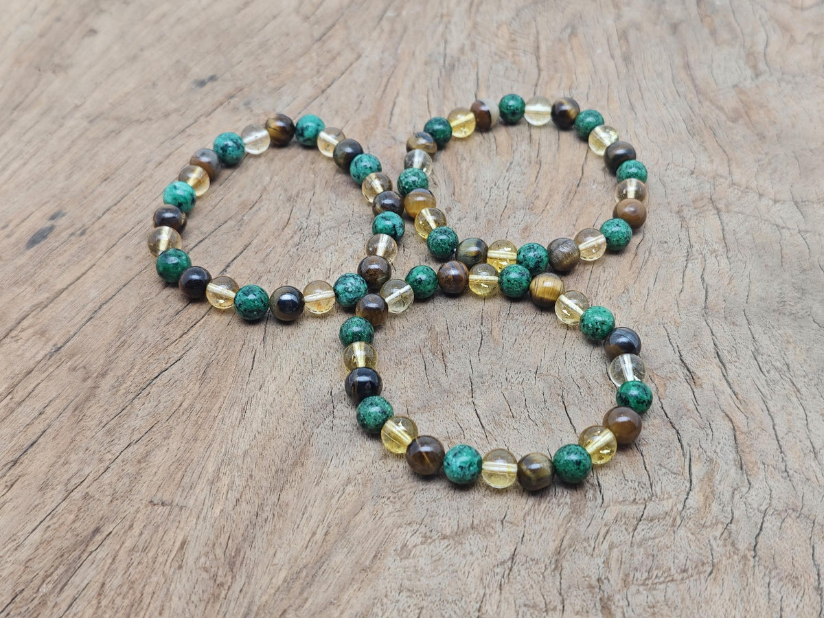 Handmade abundance and prosperity gemstone bracelet with colorful beads and a charm, designed for positive intentions.