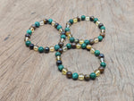 Handmade abundance and prosperity gemstone bracelet with colorful beads and a charm, designed for positive intentions.