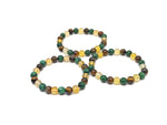 Handmade gemstone bracelet with colorful beads, designed for abundance and prosperity, featuring natural stones and adjustable cord.