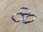 Handmade gemstone sleep bracelet with colorful beads and adjustable cord, designed for relaxation and positive intentions.