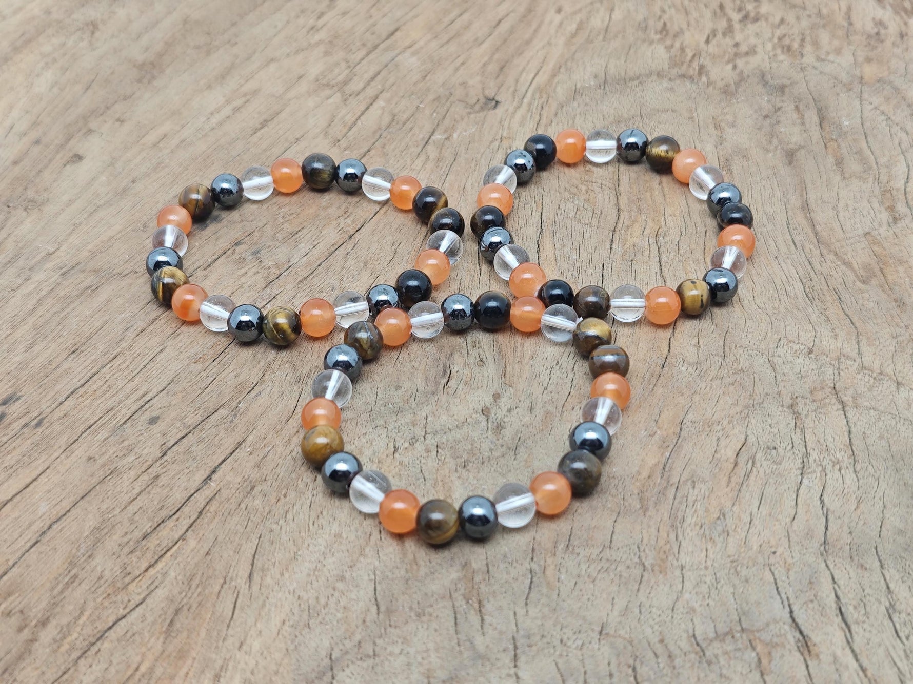 Handmade gemstone confidence bracelet with colorful beads and a silver charm, designed for positive intentions.