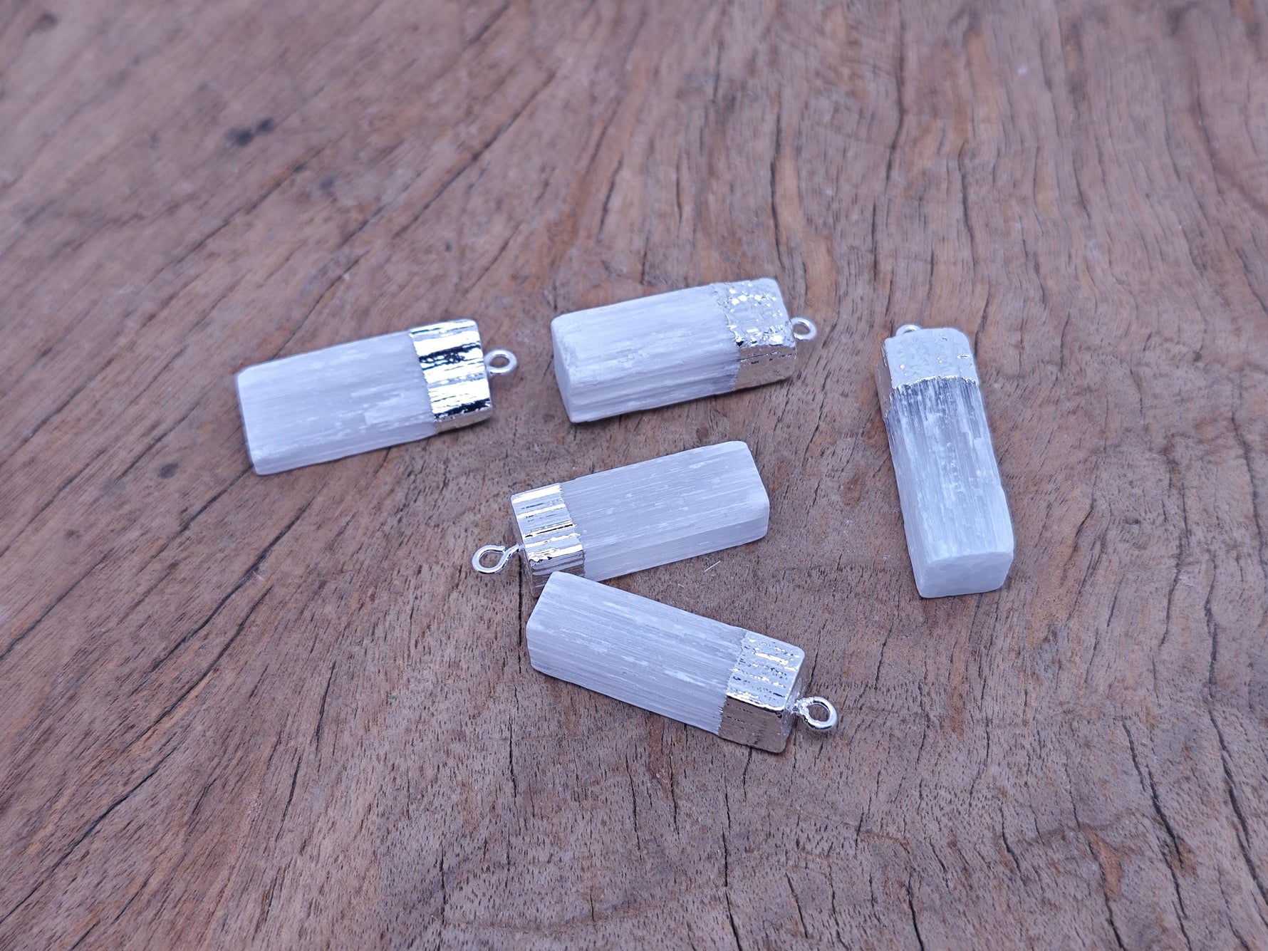 Selenite stick pendant from GemstoneGO featuring a clear, healing crystal pendant on a cord, ideal for spiritual and crystal healing.