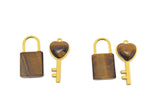 Tiger Eye heart crystal pendant by GemstoneGO featuring a polished tiger eye stone in a heart shape with a silver bail.
