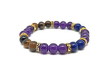 Handmade triple protection gemstone bracelet with colorful beads and a charm, designed for positive energy and intention.