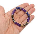 Handmade triple protection gemstone bracelet with colorful beads and charms, designed for intention and positive energy.