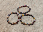 Handmade sacral chakra gemstone bracelet with colorful beads, designed for intention and energy balance by GemstoneGO.