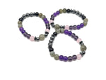 Handmade Triple Prosperity Gemstone Bracelet featuring colorful polished stones on an elastic band, designed for positive intentions.