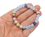 Handmade third eye chakra gemstone bracelet with blue and purple beads, featuring a silver charm, designed for intention and spiritual balance.