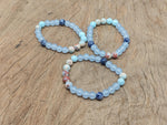 Handmade third eye chakra gemstone bracelet featuring colorful natural stones and adjustable cord for spiritual intention and style.