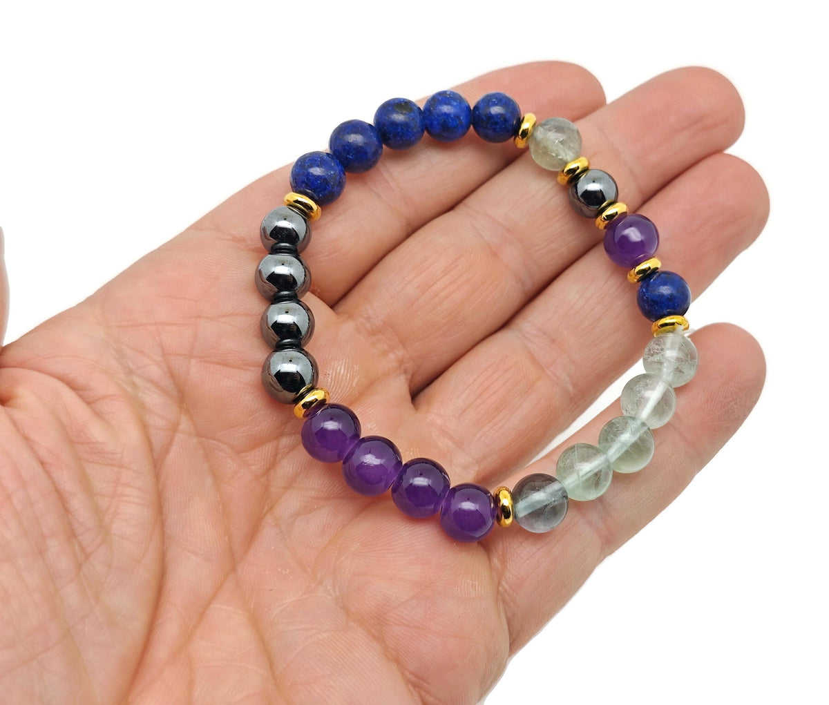 Handmade root chakra gemstone bracelet featuring colorful beads and a silver clasp, designed for balancing energy and intention.