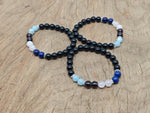 Handmade Throat Chakra gemstone bracelet with blue beads, featuring a silver charm, designed for intention and energy balancing.