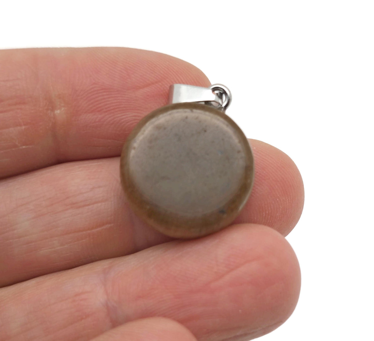 Tiger Eye flat round gemstone pendant featuring a crystal coin design, showcasing warm golden-brown hues and polished surface.