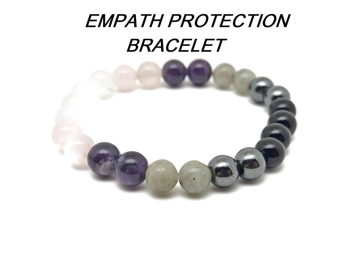 Handmade Empath Protection gemstone bracelet with natural stones on a soft fabric background, featuring an intention-setting design.