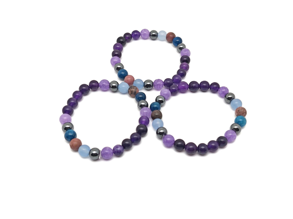 Handmade Heal gemstone bracelet with colorful stones and adjustable cord, designed for positive intentions and healing.