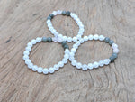 Handmade gemstone balance bracelet featuring colorful beads and a central charm, designed for intention and harmony.