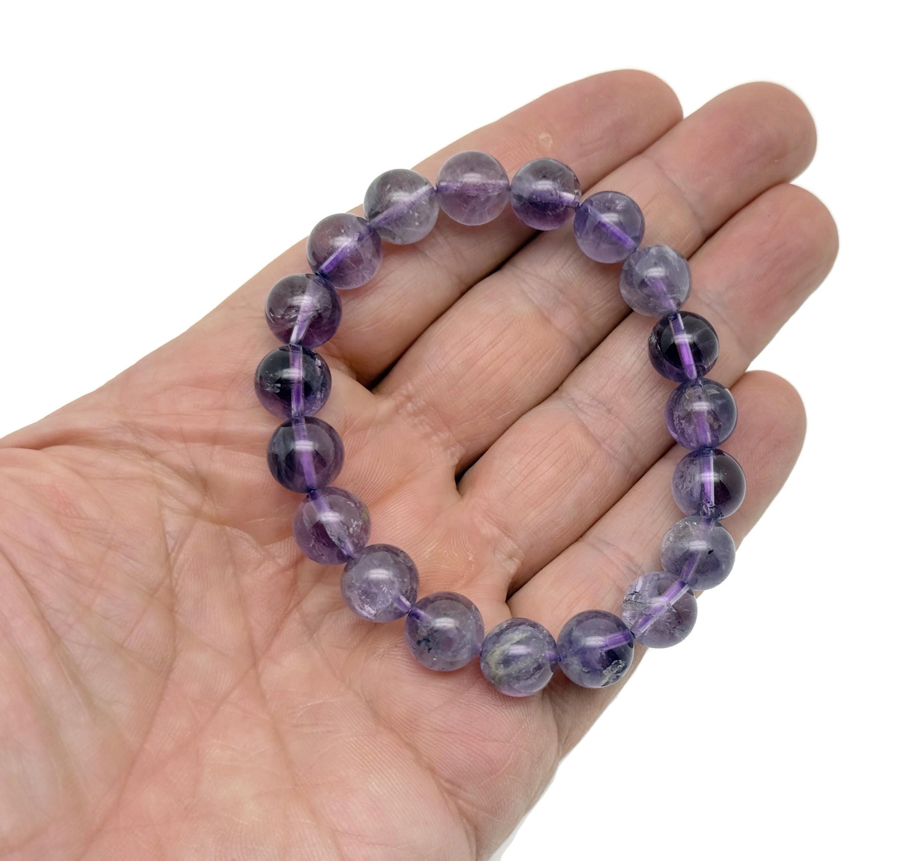 Amethyst beaded crystal bracelet for men and women, stretchy jewelry with healing properties, featuring polished purple gemstones.