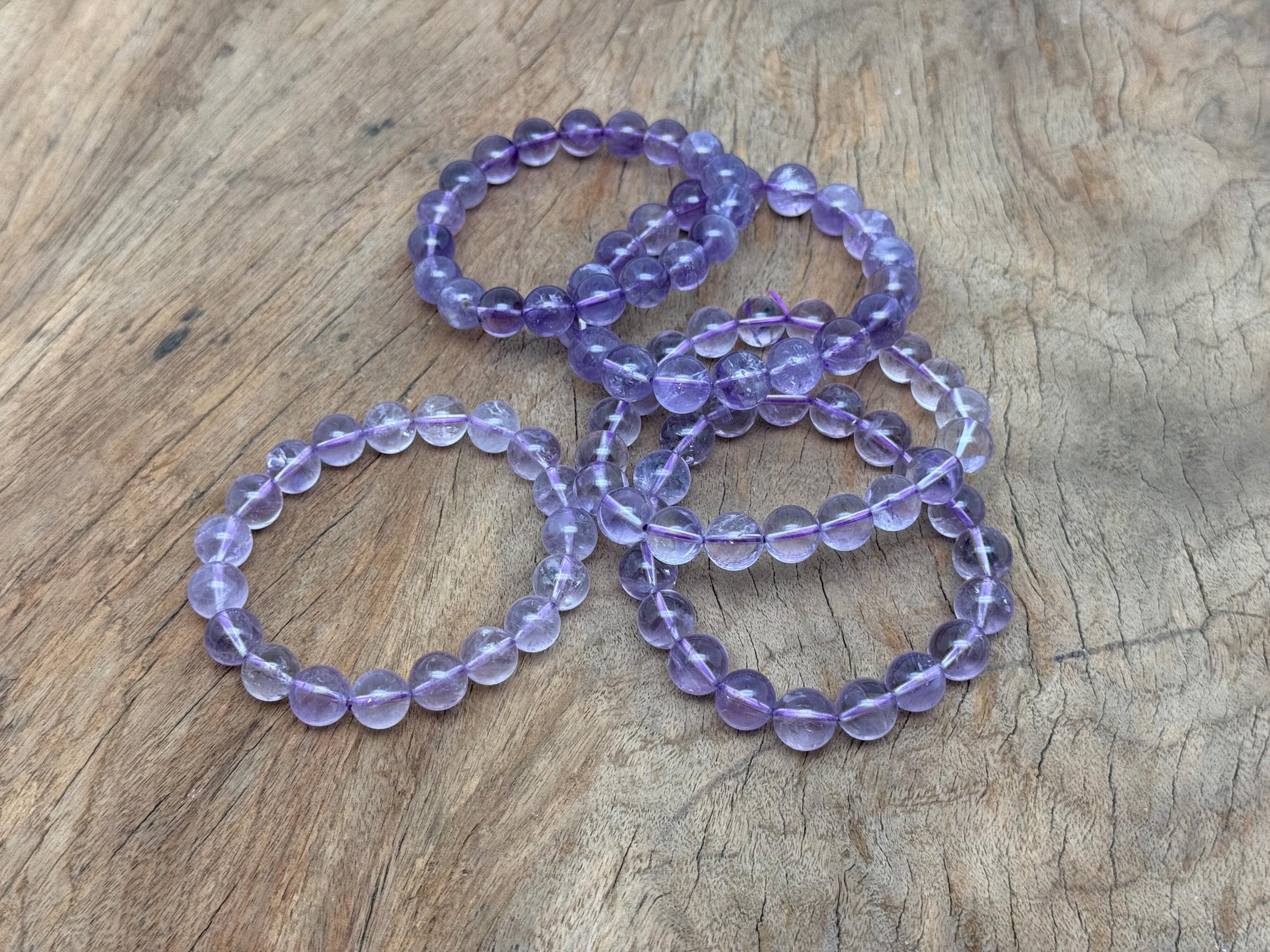 Amethyst beaded crystal bracelet for men and women, stretchy design with polished purple gemstone beads, suitable for crystal healing.