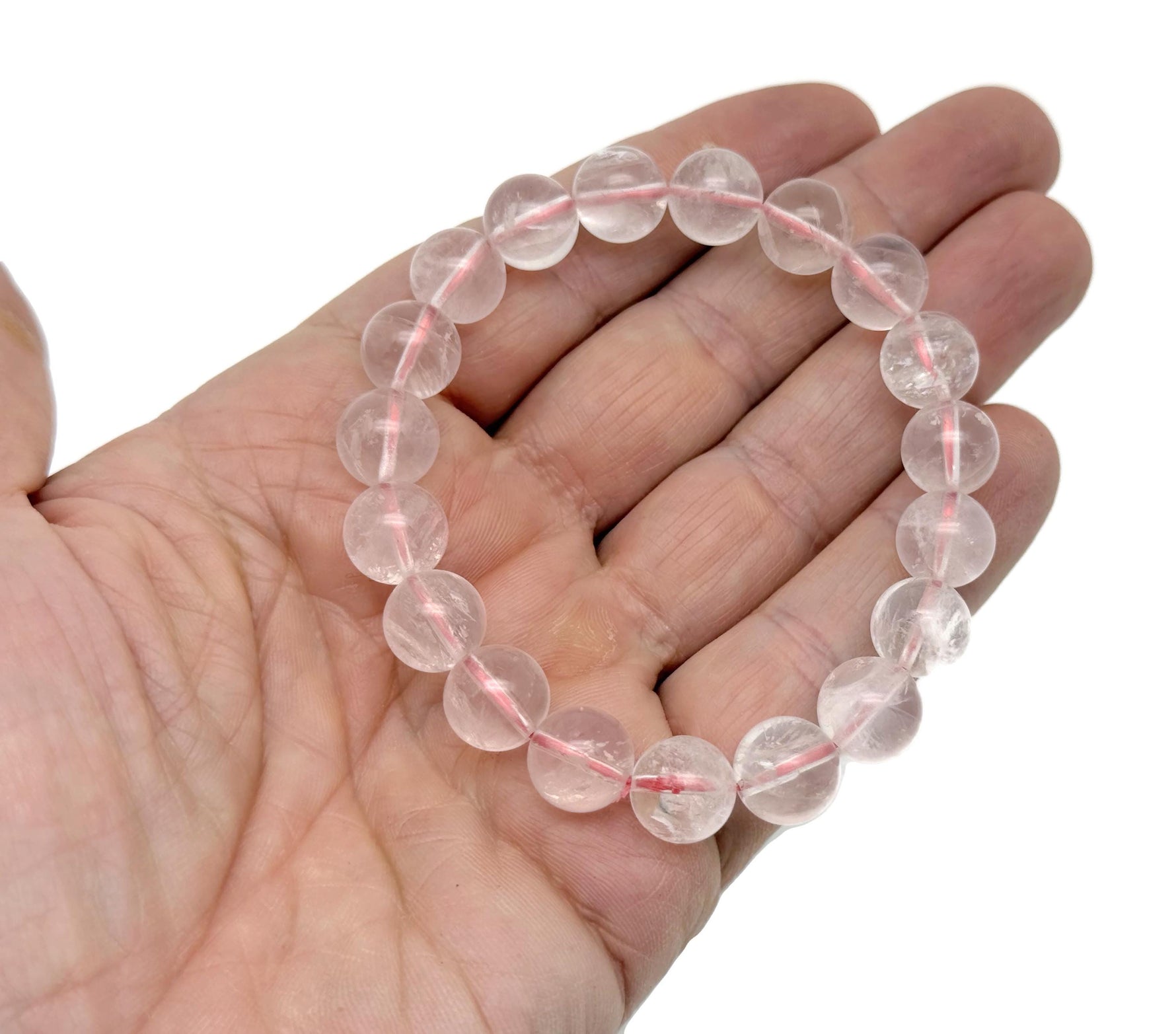 Rose quartz beaded crystal bracelet for men and women, stretchy jewelry with healing properties, featuring polished pink stones.