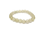 Citrine beaded crystal bracelet for men and women, stretchy jewelry with healing properties, featuring vibrant yellow-orange stones.