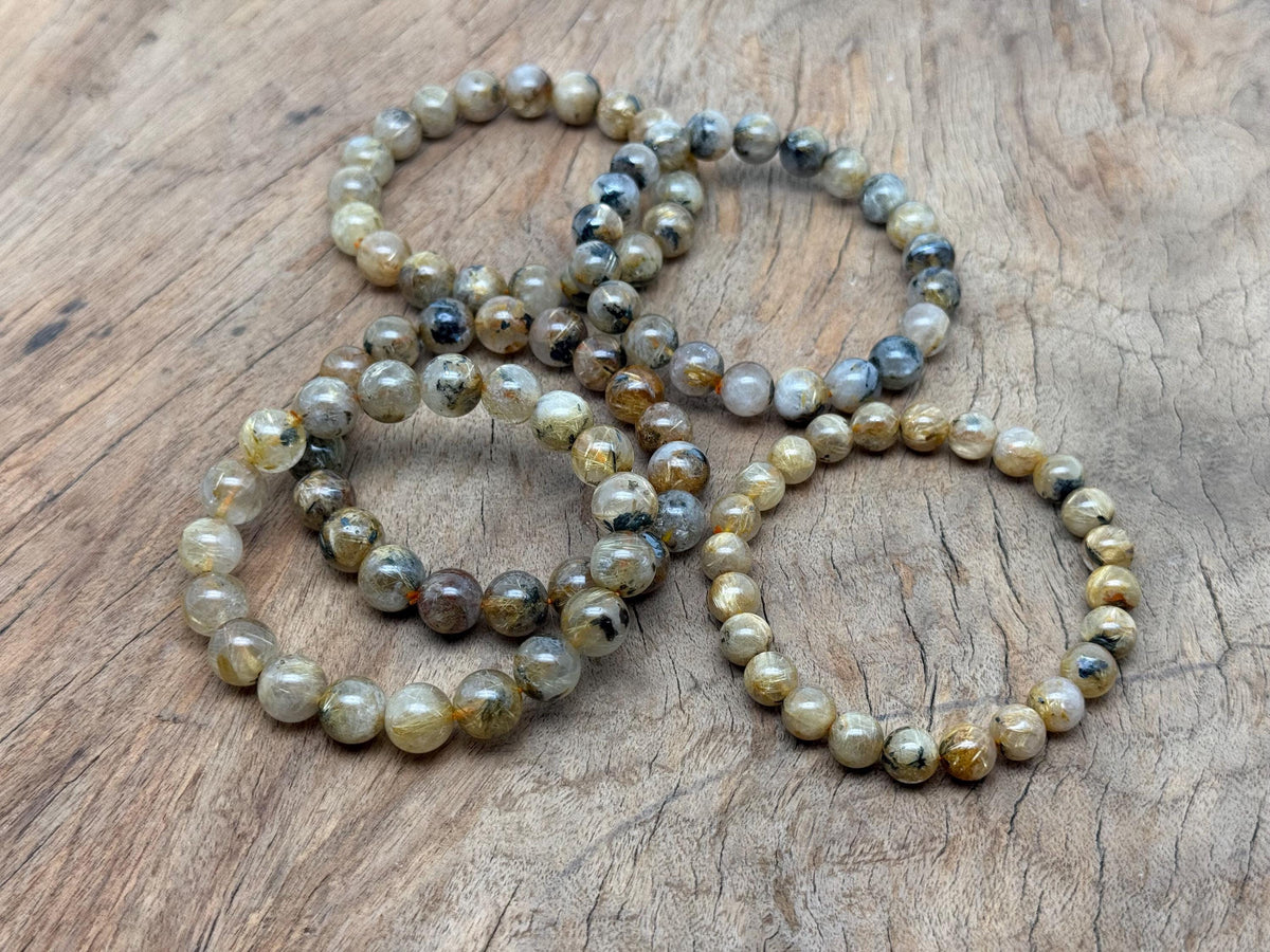 Golden rutilated quartz beaded bracelet with stretchy band, suitable for men and women, ideal for crystal healing.