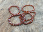 Beaded crystal healing bracelet for men and women with stretchy band, featuring polished AA-grade crystals from GemstoneGO.