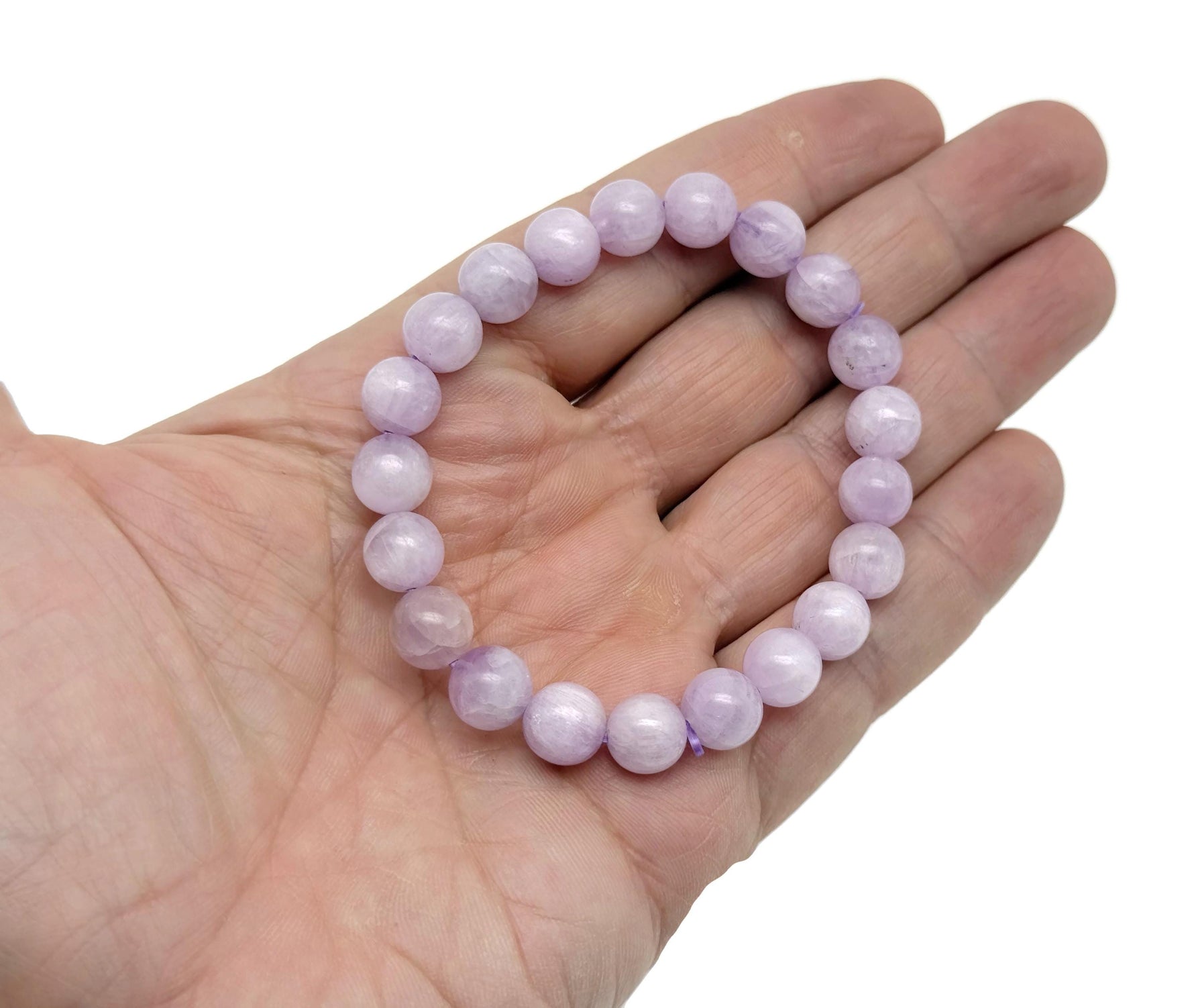 Kunzite beaded crystal bracelet for men and women, stretchy jewelry with healing properties, featuring pinkish-purple gemstones.