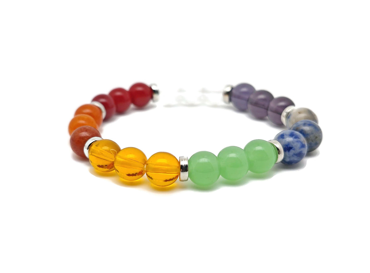 Handmade 7 Chakra gemstone bracelet with colorful stones on an elastic band, designed for intention and spiritual balance.