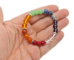 Handmade 7 Chakra gemstone bracelet with colorful beads and adjustable cord, designed for intention and spiritual balance.