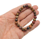 Handmade sacral chakra gemstone bracelet featuring vibrant orange stones and adjustable cord for positive energy and intention.