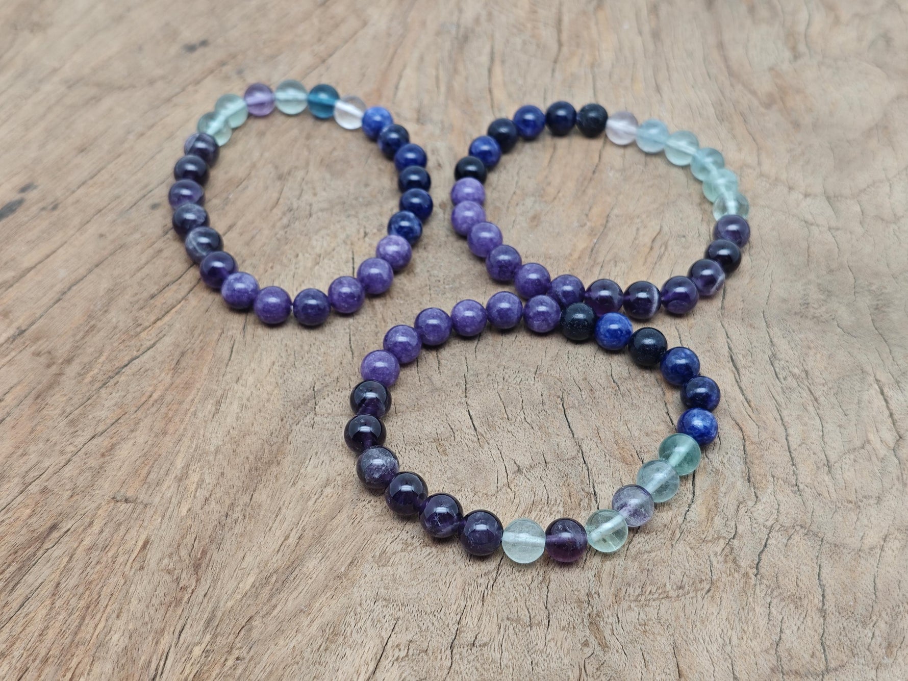 Handmade gemstone bracelet with colorful beads and silver accents, designed for intention and personal transformation.