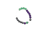 Handmade gemstone bracelet featuring colorful beads and a charm, designed for inner strength and positive intentions.