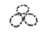 Handmade Crown Chakra gemstone bracelet featuring colorful beads, designed for spiritual intention and chakra balancing.