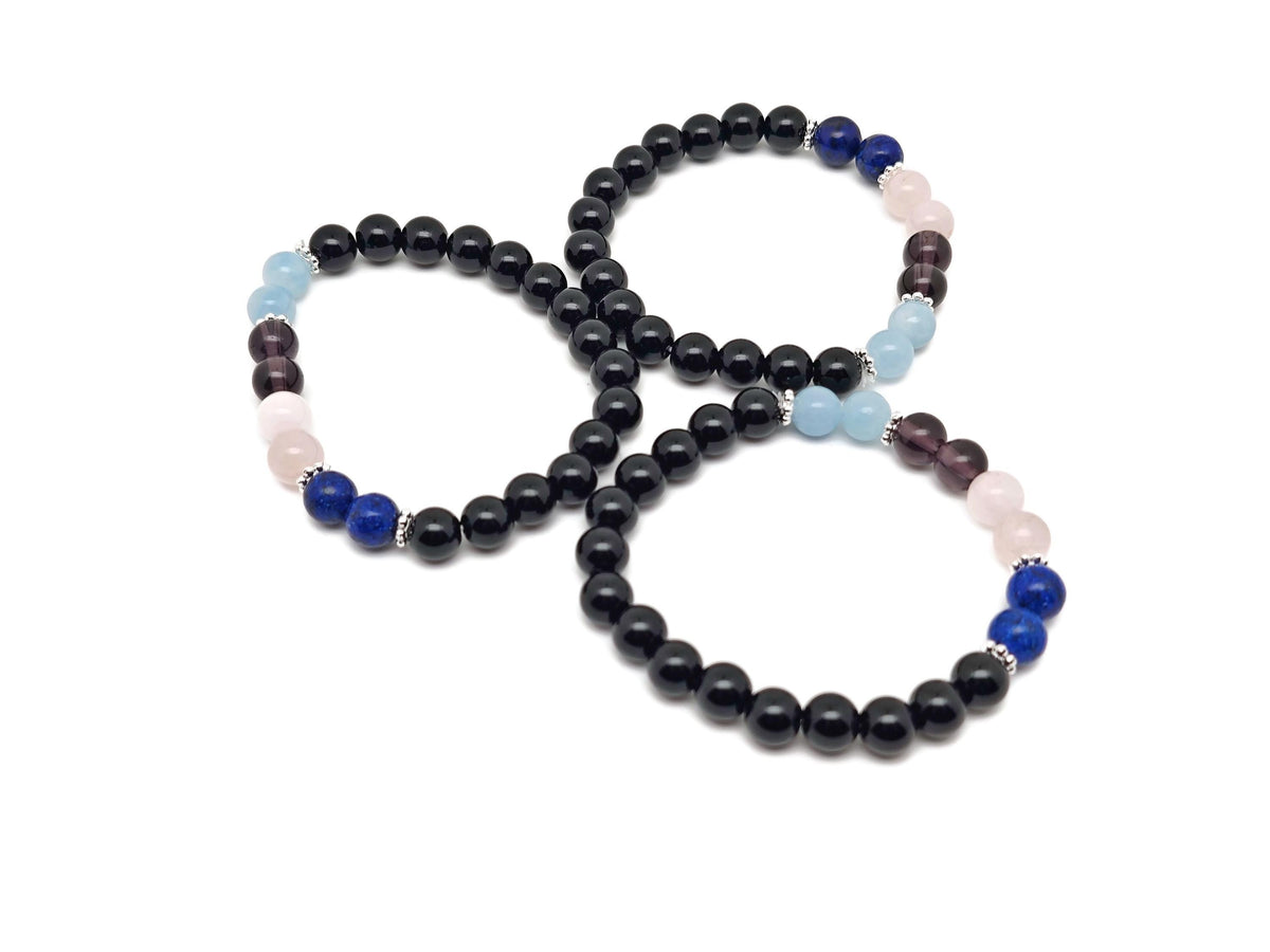 Handmade Throat Chakra gemstone bracelet with blue beads and silver accents, designed for chakra healing and intention setting.