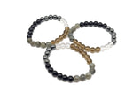 Handmade anti-anxiety gemstone bracelet with colorful beads and a silver charm, designed for calming and positive intentions.
