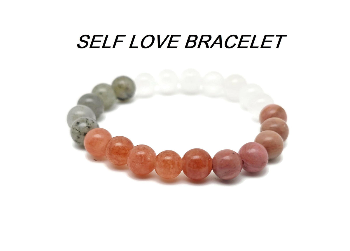 Handmade self-love gemstone bracelet with colorful beads and a silver charm, designed for positive intentions and personal empowerment.