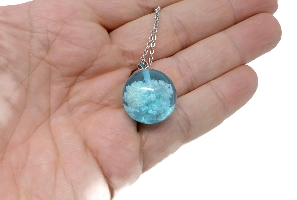 White Clouds Luminous Necklace by GemstoneGO featuring a transparent round ball with blue sky and white cloud design.