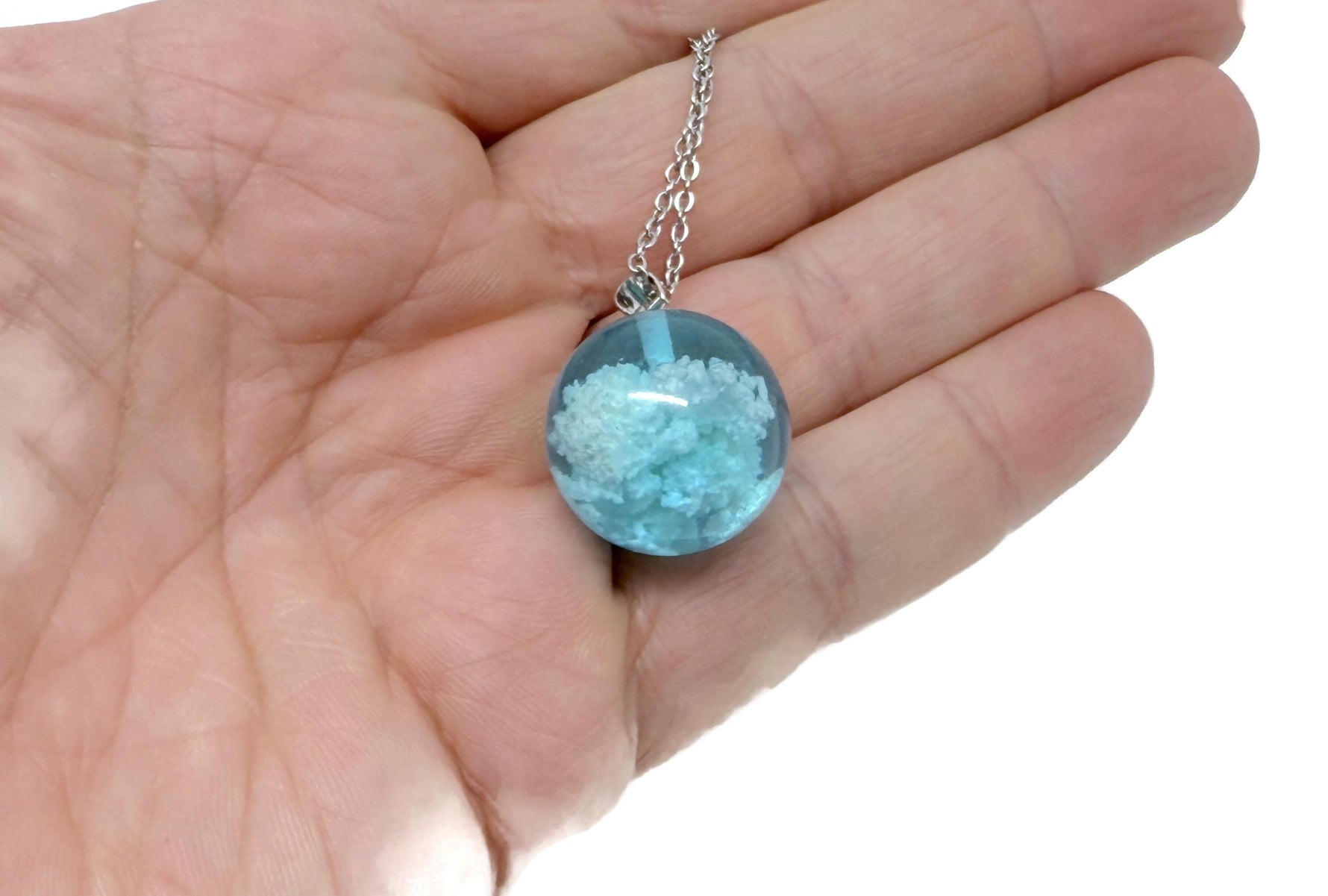 White Clouds Luminous Necklace by GemstoneGO featuring a transparent round ball with blue sky and white cloud design.