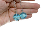 White Clouds Luminous Necklace with transparent round blue sky and white cloud pendant by GemstoneGO, glowing softly in the image.