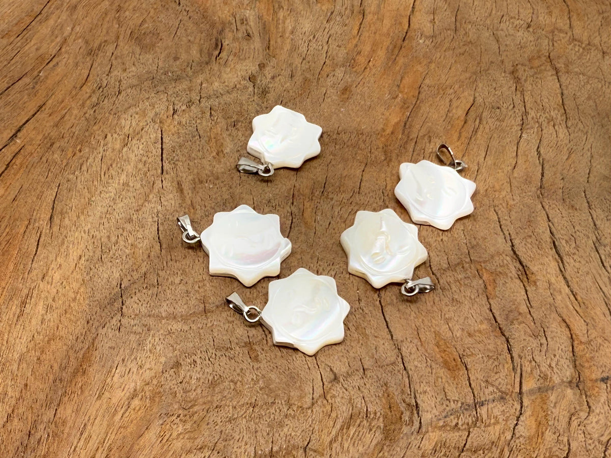 Natural pearl sun face pendant with gemstone and sea shell accents, crafted by GemstoneGO, showcasing detailed jewelry design.